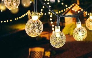 Fairy lights wall hanging decor with glowing glass ball bulbs for indoor and outdoor decoration.